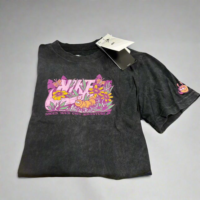 Nike Girls’ Graphic T-Shirt in black, size M, with a vibrant floral design, ideal for casual and everyday wear.