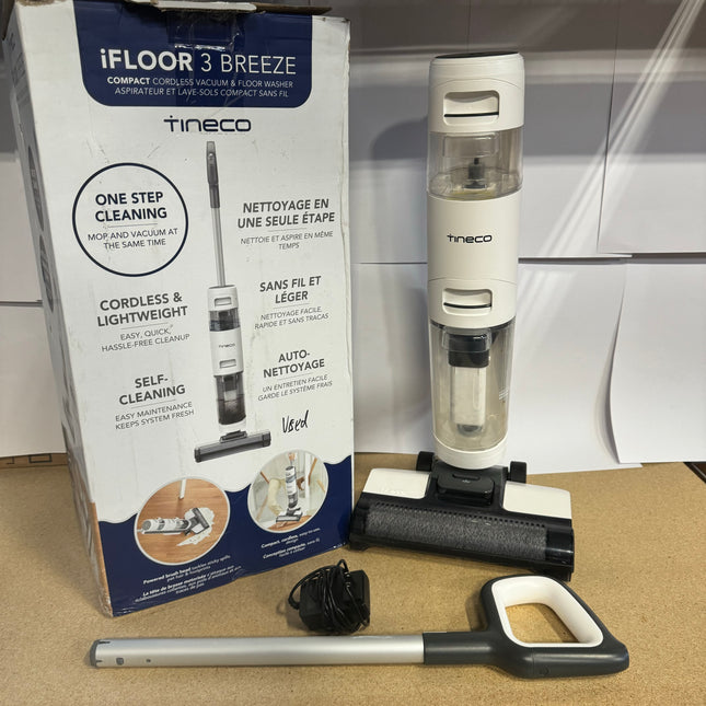 Tineco iFLOOR 3 Breeze Compact Cordless Vacuum & Floor Washer, slightly used, includes main unit, handle, charging adapter, and original packaging. Ideal for hard floors with self-cleaning function.