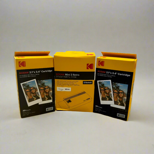 Kodak Mini 2 Retro 2.1x3.4” portable Bluetooth instant photo printer in white with 2 packs of Kodak 2.1”x3.4” Cartridges (30 sheets each), producing high-quality color prints. Ideal for scrapbooking, decorating, and gifting.