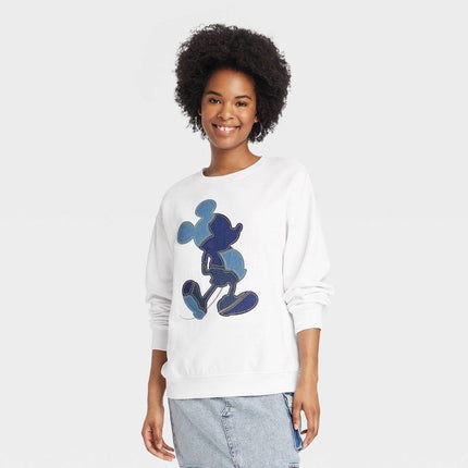 Mickey Mouse sweatshirt with blue denim applique on white fabric.
