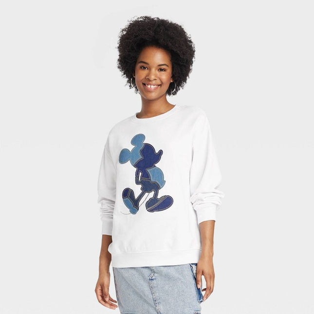 Mickey Mouse sweatshirt with blue denim applique on white fabric.