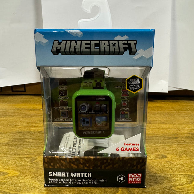 Minecraft Smartwatch in packaging, featuring a touch screen, six games, and multifunctional capabilities.